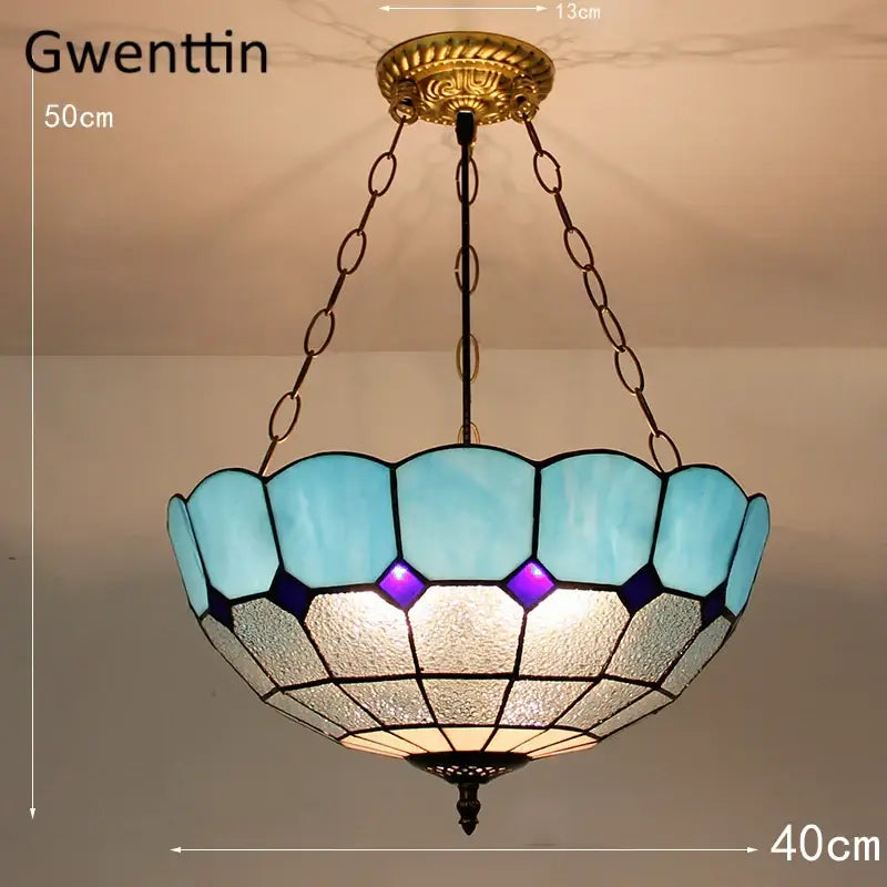 Gwenttin pendant light with turquoise and purple diamond square stained glass shade and brass fixture for kitchen use