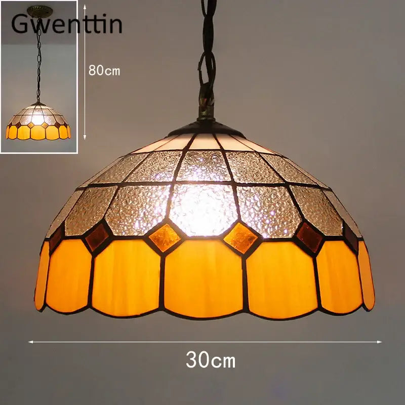 A warm-toned hexagonal pendant light with amber and frosted glass panels featuring diamond square stained design