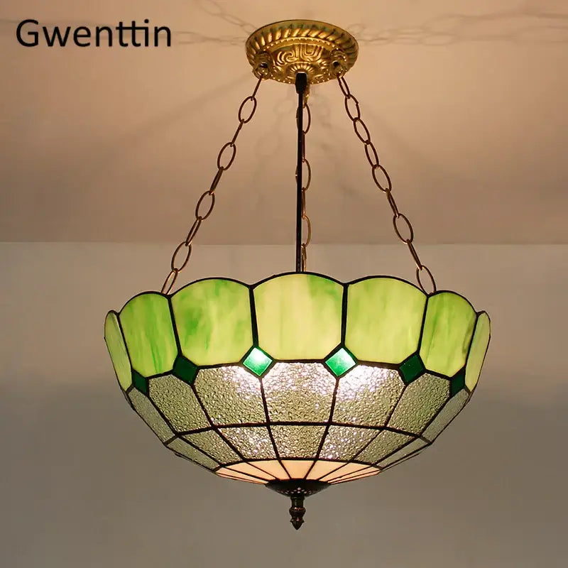 Vintage-style pendant light with scalloped green and cream diamond square stained glass shade for kitchen use
