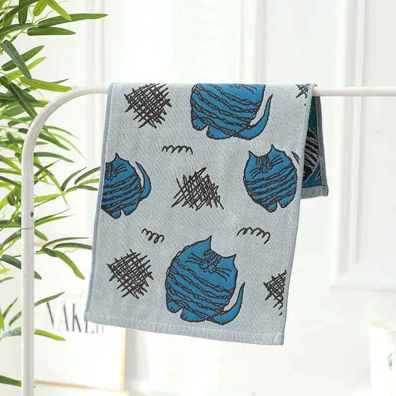 Light gray cotton gauze hand and face towel with blue cartoon cats and black scribble patterns from decorbites cotton gauze set