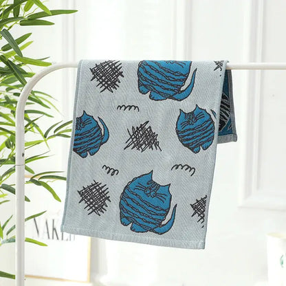 Light gray cotton gauze hand and face towel with blue cartoon cats and black scribble patterns from decorbites cotton gauze set