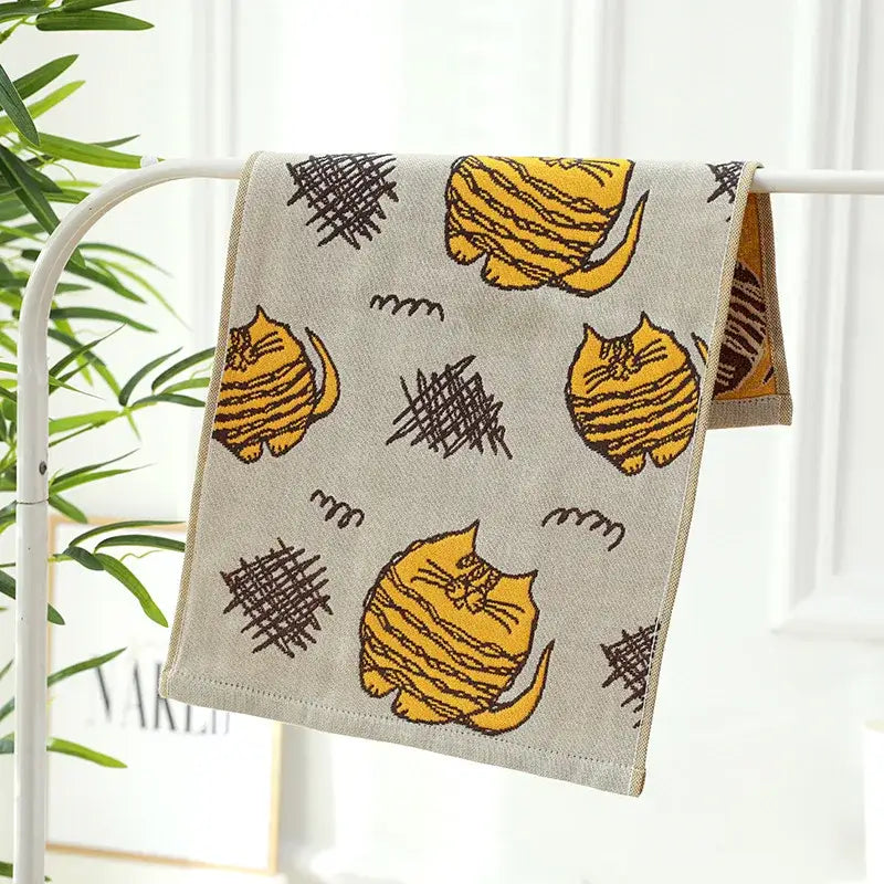 Beige decorbites cotton gauze face towel with yellow striped cats and black scribble patterns for bathroom use