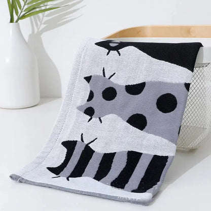 A soft knitted baby blanket with black and gray cartoon animals on white decorbites cotton gauze face towel