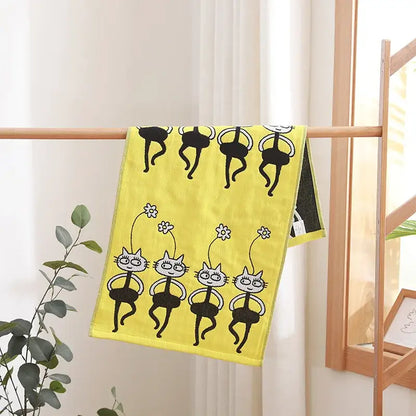 Bright yellow decorbites cotton gauze face towel with playful black and white cartoon cat ballet patterns and flowers
