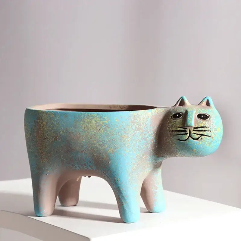 Turquoise ceramic cat succulent plant pot with distressed finish and black embroidered facial features for living room decor