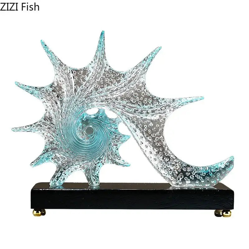 Turquoise and clear glass bubble conch sculpture with swirling spiral design on black wooden base for bedroom decor