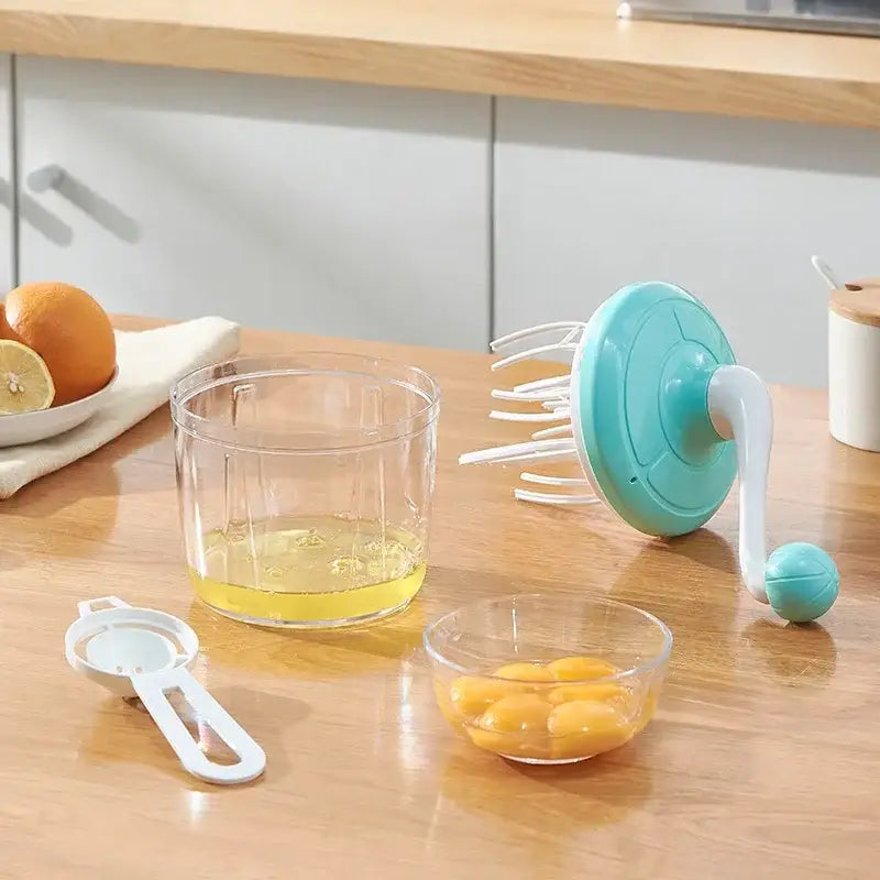 Teal and white hand mixer whisk beater with hand crank for efficient kitchen food processing and egg separation