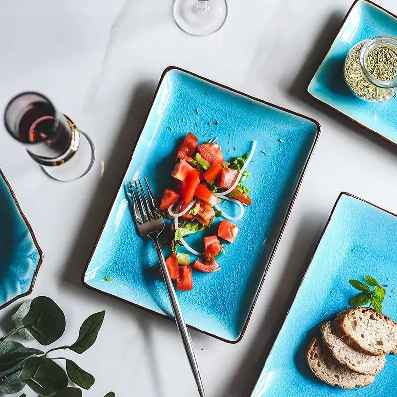 Vibrant turquoise crack glaze ceramic plate with dark brown rim and textured surface from decorbites blue ice collection