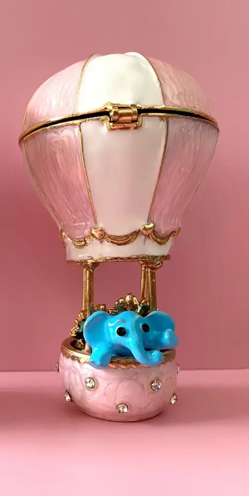 Delicate pink hot air balloon trinket box with gold accents and crystal animal figurines decorbites detail
