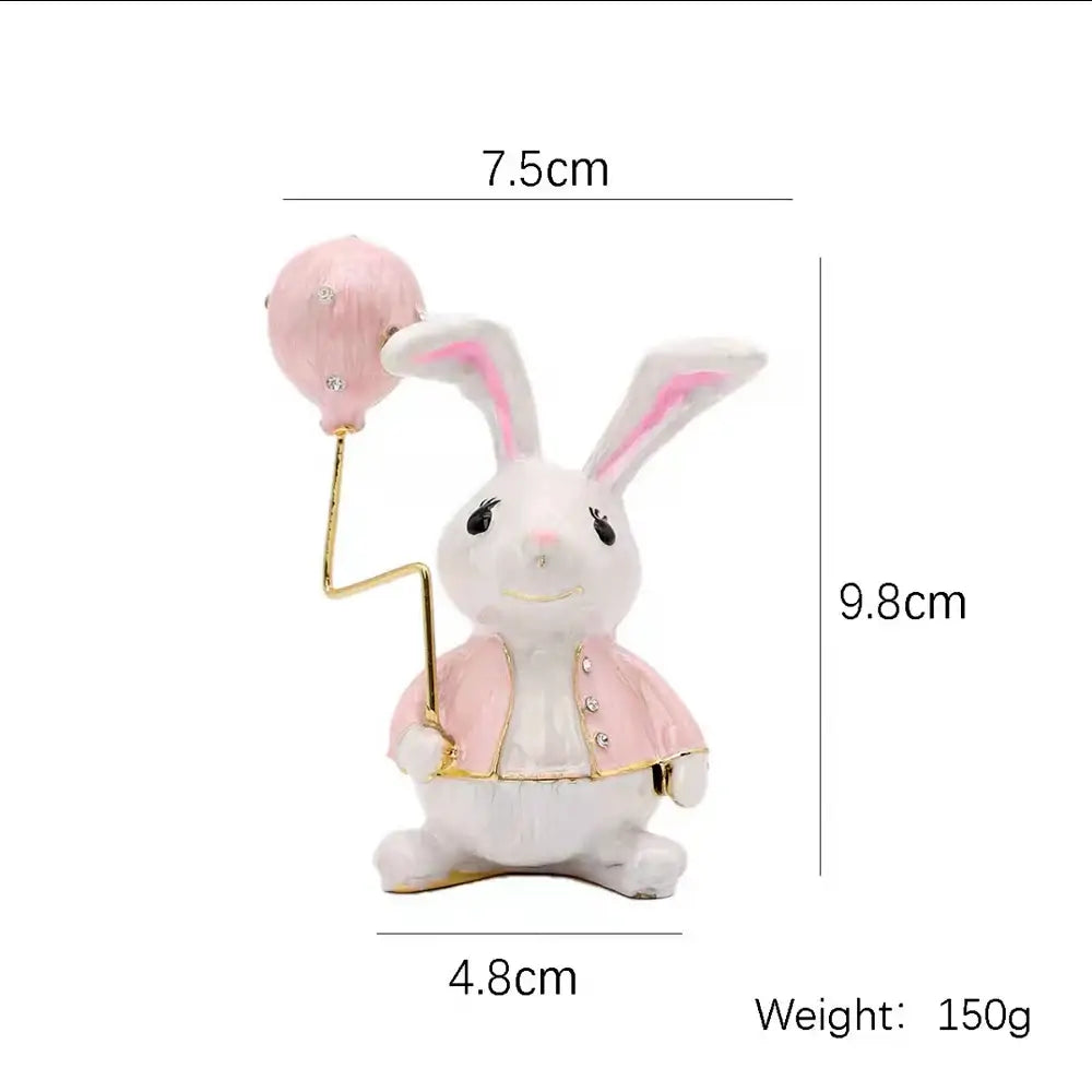 A white rabbit figurine holding a glittery pink balloon in a decorbites crystal animal trinket box for bedroom decor
