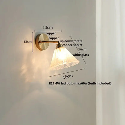 Copper-finished wall sconce with white textured glass shade complements decorbites blue glass wall for staircases with pull chain