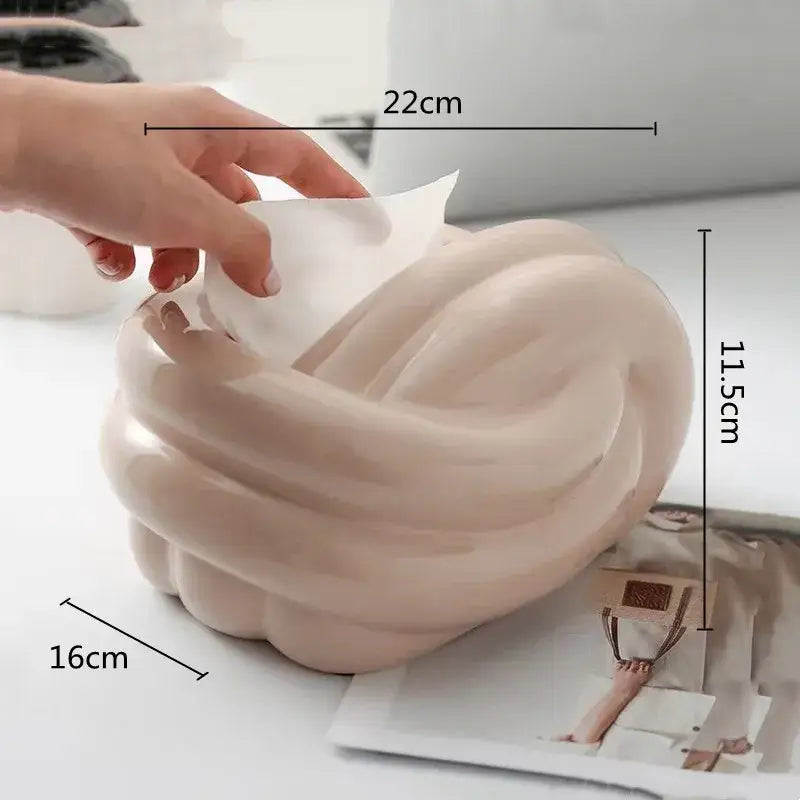 Cream-colored glossy ceramic desktop storage tissue box with twisted knot design for living room decorbites ceramic desktop