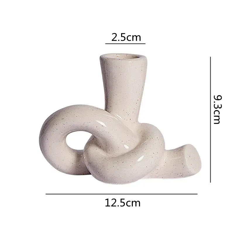 Cream-colored ceramic desktop storage tissue box with modern twisted knot design for decorbites ceramic desktop use