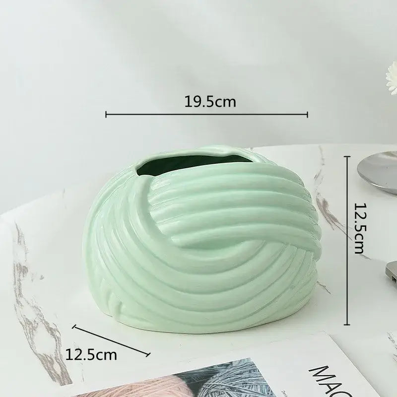 A mint green ceramic desktop storage vase with ribbed twisted design for decorbites ceramic desktop use