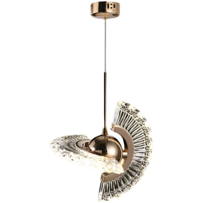 Gold and clear crystal pendant light with intricate floral design, modern style.