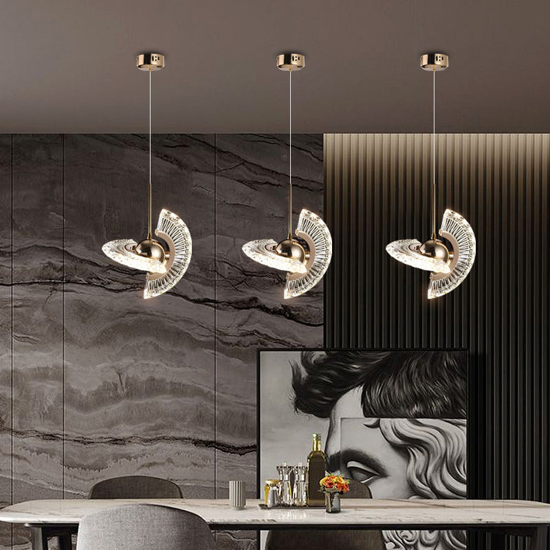 Three-tiered pendant light with metallic finish and glass accents, modern design.