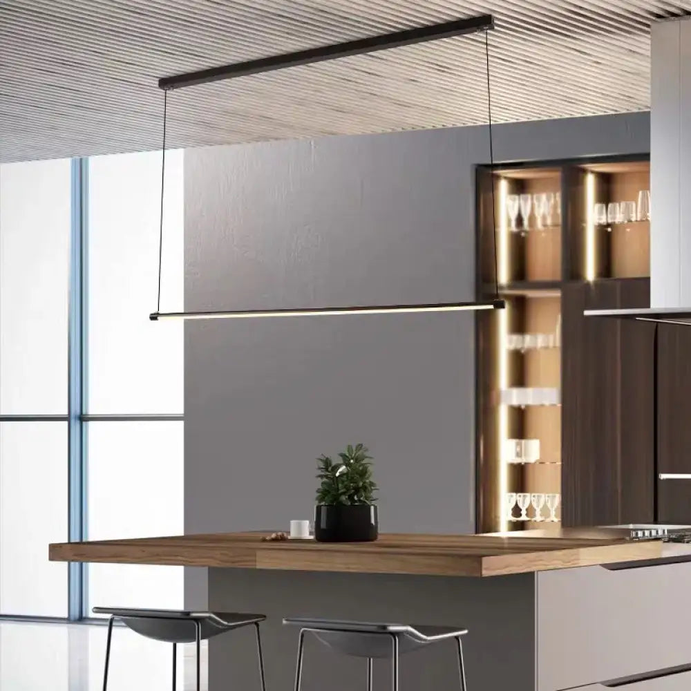 Modern black ultra slim tube led office hanging lamp with warm white light above wooden kitchen island