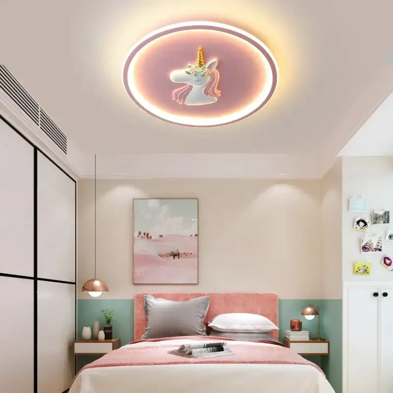 A circular kids ceiling light with a glowing pink and white unicorn design and soft ambient blue and pink lighting decorbites cartoon kids