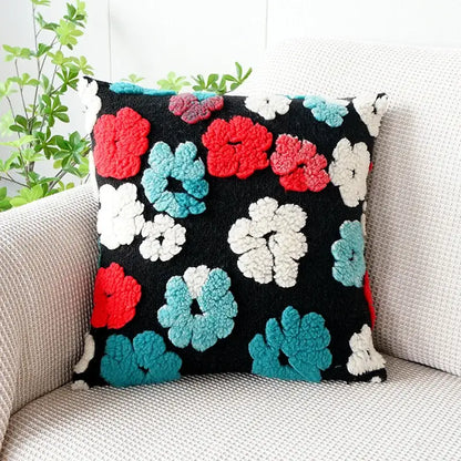 Black pillow case featuring raised fluffy red white and teal floral patterns in decorbites 3d floral jacquard design