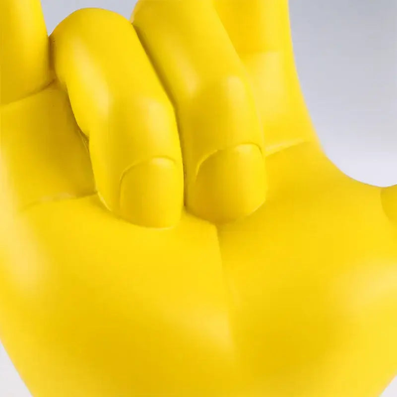 Bright yellow glossy plastic hand shaped chair with fingers slightly curled decorbites abstract hand love sculpture decor