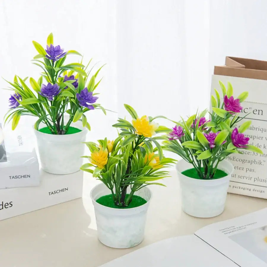 Three artificial flowers bonsai in white ceramic pots with purple and yellow decorbites artificial flowers for living room decor