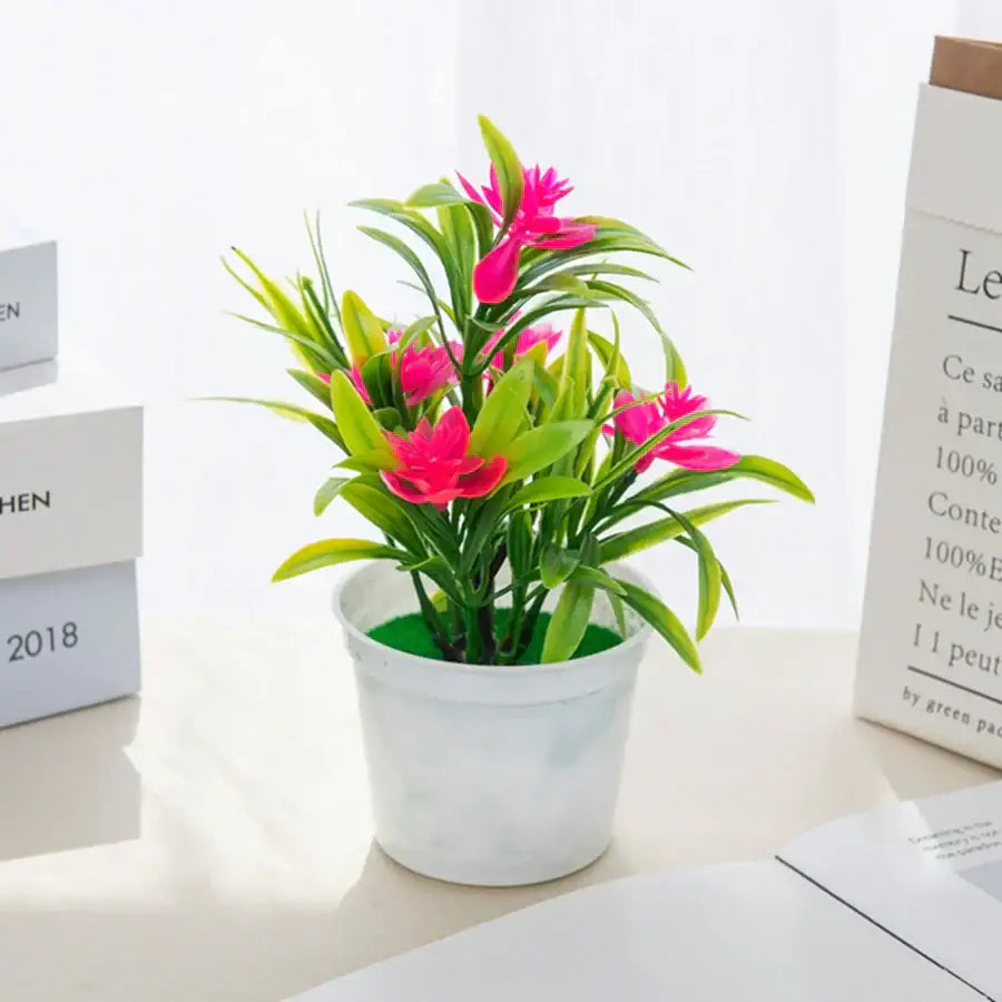 A vibrant pink artificial flowers bonsai arrangement with green leaves in a white ceramic vase for living room decorbites artificial flowers