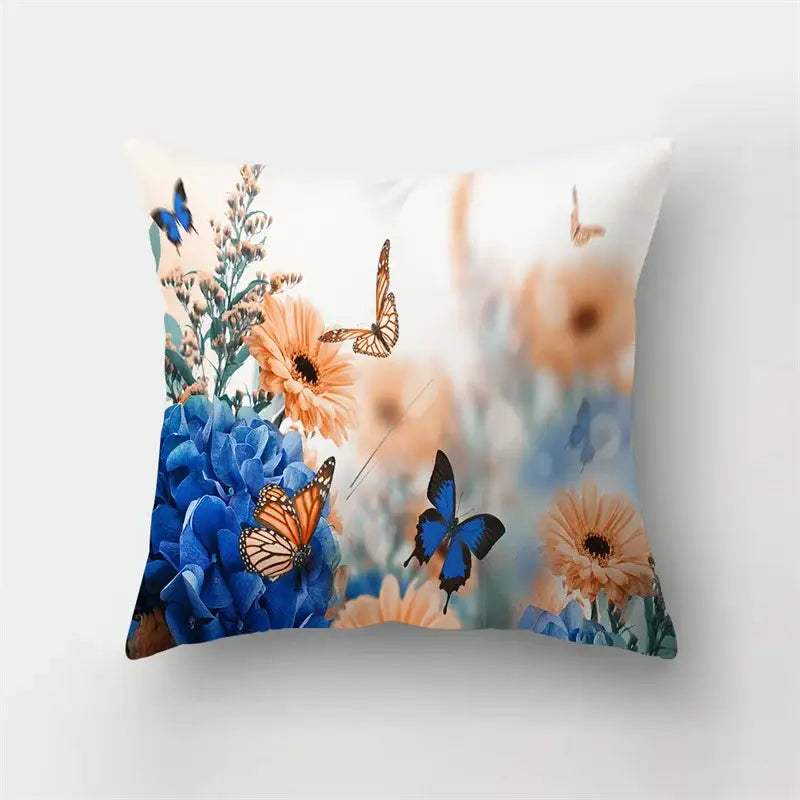 A square butterfly flower pillow with vibrant blue hydrangeas orange daisies and butterfly decorbites butterfly flower design