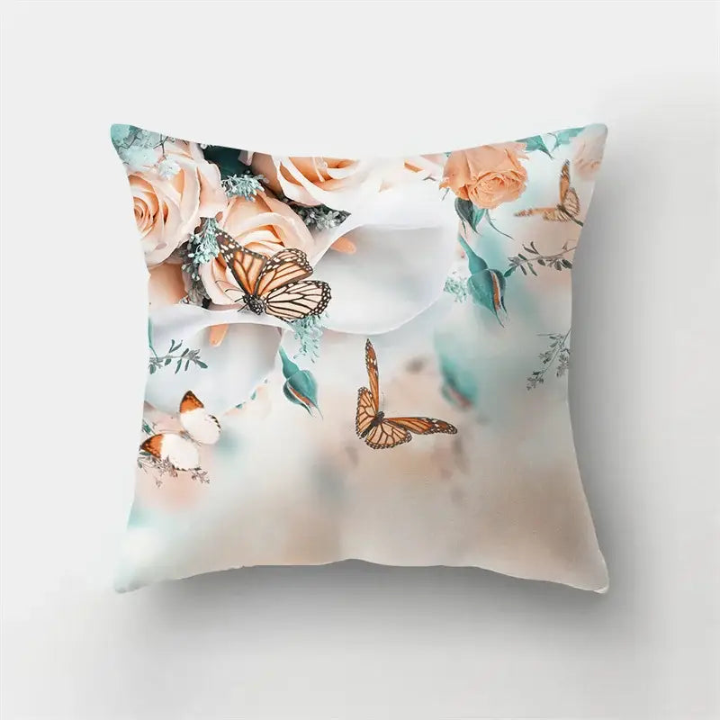 Square throw pillow with vibrant butterfly flower watercolor design of peach roses and orange monarchs on cream decorbites butterfly flower pillow case