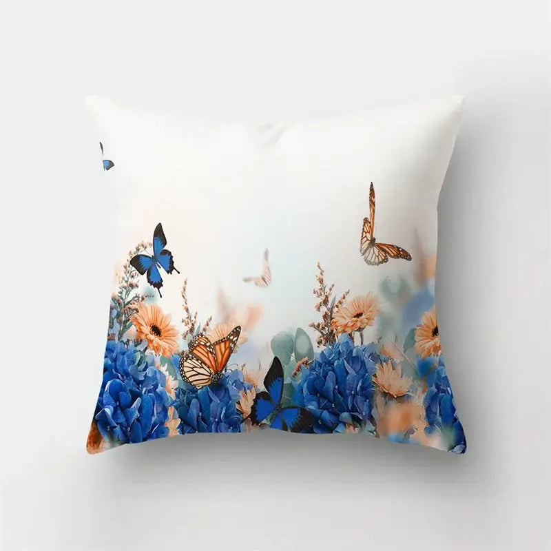 White throw pillow with vibrant blue hydrangeas orange monarch butterflies and soft peach flowers butterfly flower pillow case
