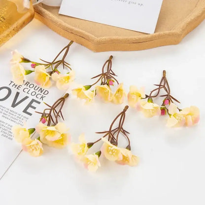 Delicate decorbites artificial flowers with pale yellow petals and pink buds on brown stems for living room decor