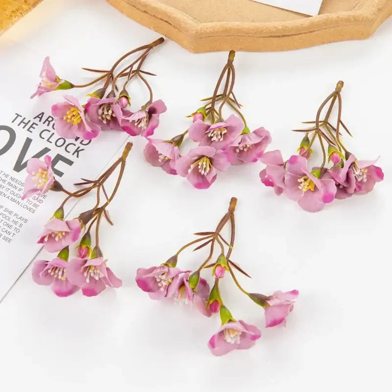 Vibrant pink artificial cherry blossom flowers with delicate petals and yellow centers on brown stems for decorbites artificial decor
