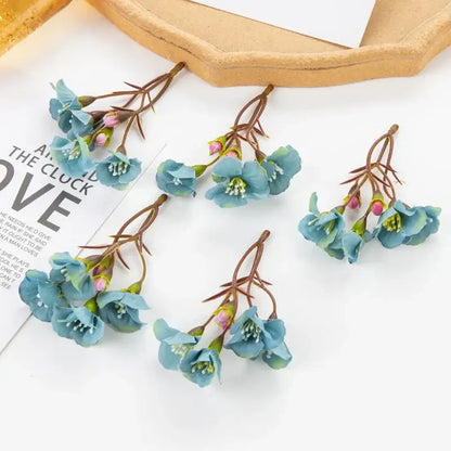 Vibrant cherry blossom artificial flowers with blue petals green stems and pink buds by decorbites artificial flowers for living room decor