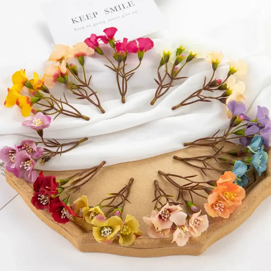 Vibrant cherry blossom decorbites artificial flowers in pink yellow purple and red arranged on a wooden tray for living room decor