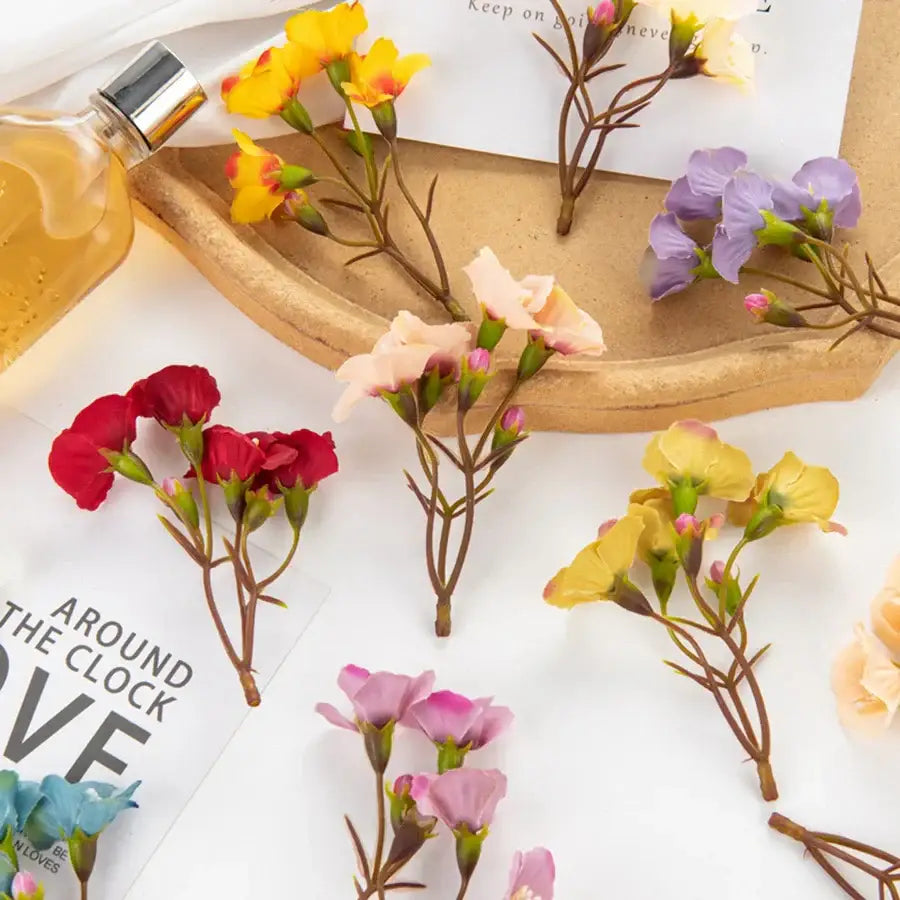 A collection of decorbites artificial flowers in vibrant red yellow purple pink and peach tones for living room decor