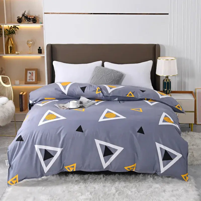 Gray duvet cover with modern geometric pattern of white black and yellow triangles in vibrant floral leaf bedding set decorbites leopard print