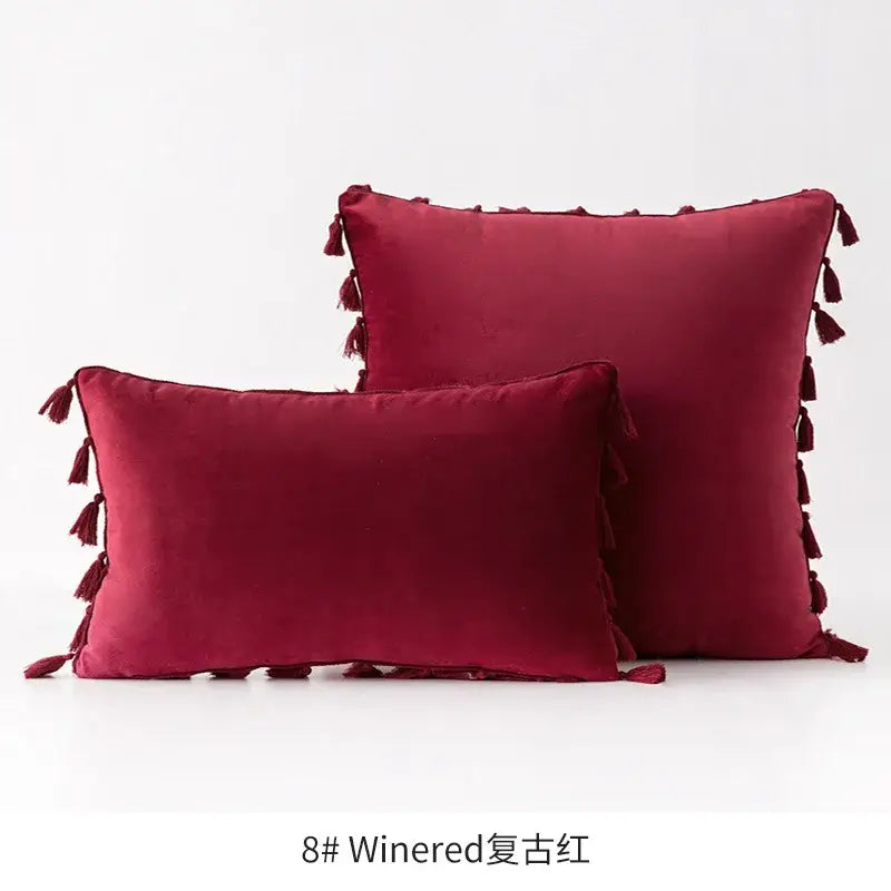Pair of burgundy tassel velvet throw pillows with decorative fringed tassel velvet edges for living room decorbites decor