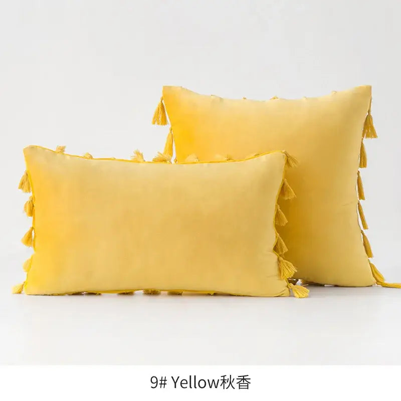 Two mustard-yellow velvet throw pillows with decorative tassels for vibrant fringed tassel velvet living room decor