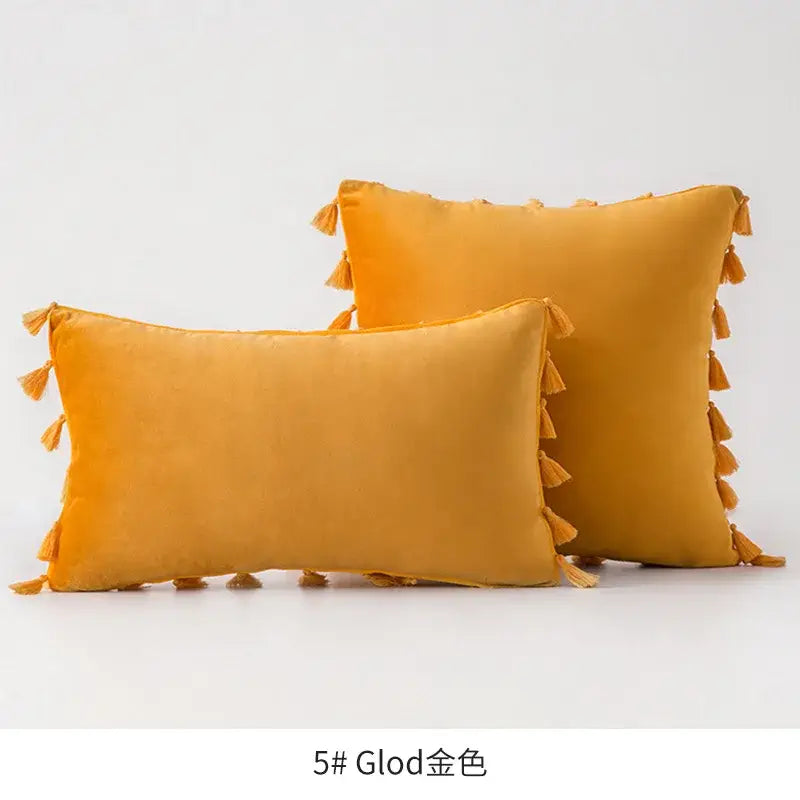 Warm golden-yellow velvet pillows with decorative fringed tassel edges for vibrant tassel velvet living room decorbites