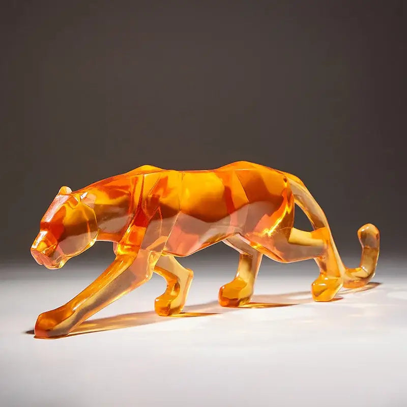 A translucent orange geometric panther figurine with faceted crystalline surfaces for decorbites leopard cheetah decor animal sculptures