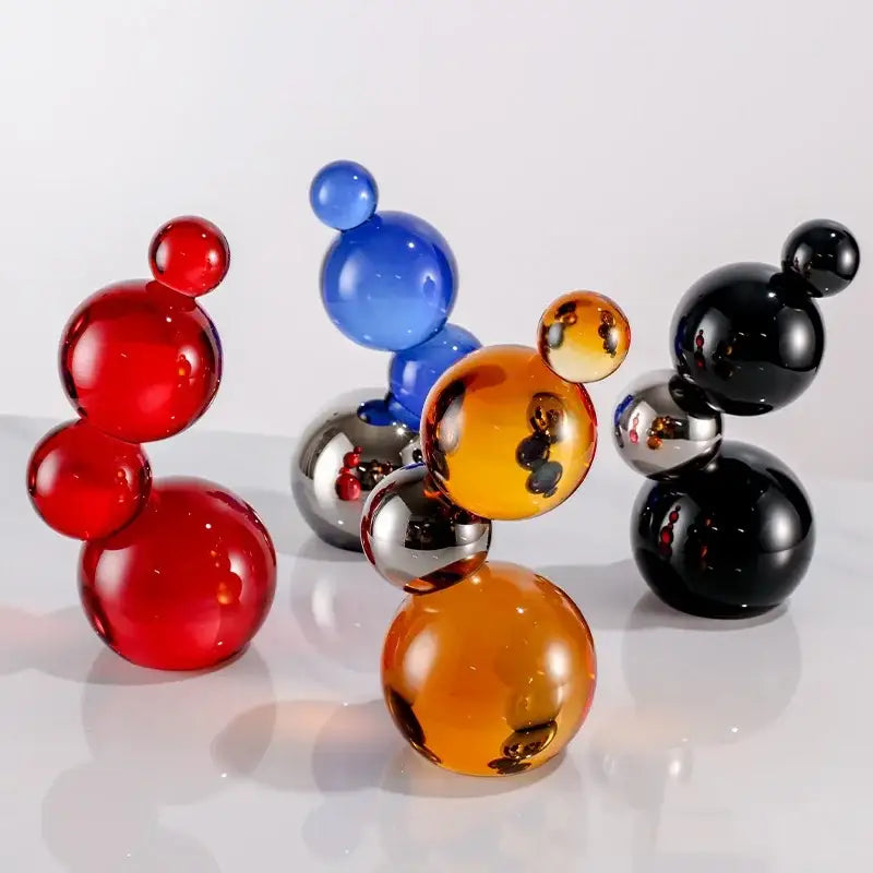 Vibrant glossy crystal bubble decor spheres in red blue orange and black with metallic accents for home decor