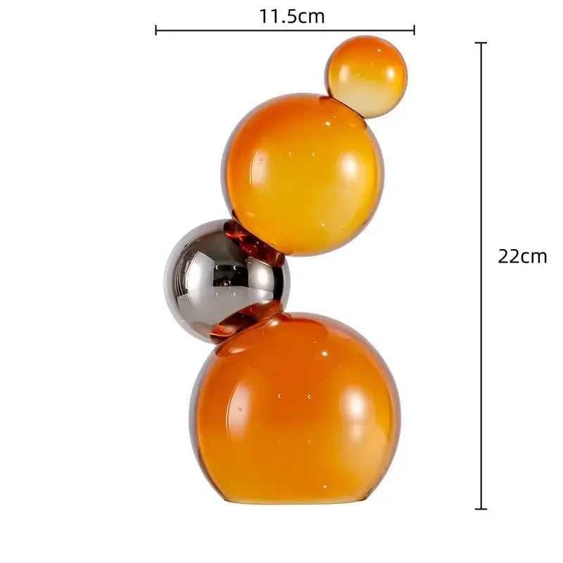 A modern glass crystal bubble decor sculpture with four amber and chrome decor spheres for home decor