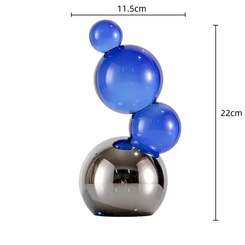 A modern crystal bubble decor sculpture with translucent blue glass spheres on a reflective chrome base for home decor