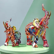 Vibrant graffiti elephant resin sculpture with bold reds yellows and blues glossy finish for living room decorbites decor