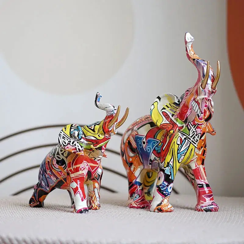 Vibrant graffiti elephant resin sculpture with bold red yellow and black designs for living room decor by decorbites