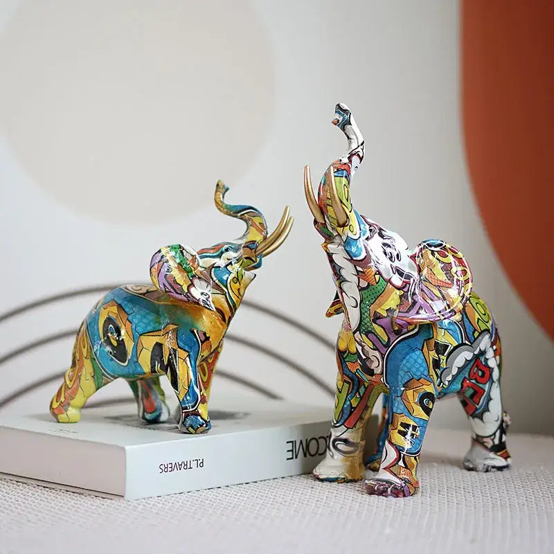 Two vibrant graffiti elephant resin sculptures with bold graffiti-inspired designs and glossy finish for living room decorbites decor