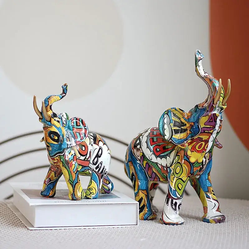 Two vibrant decorbites graffiti elephant resin sculptures with bold colors and comic book-inspired living room decor