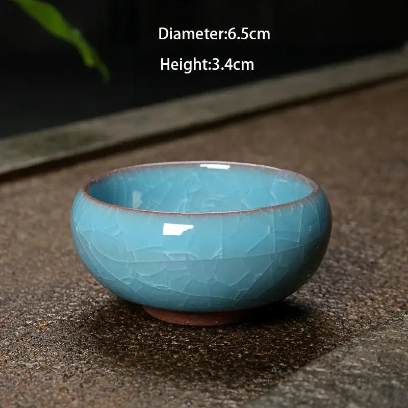 A small handcrafted ice cracking ceramic tea cup with turquoise glaze and brown rim for decorbites kitchen decor