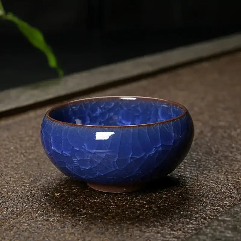 Deep cobalt blue ice cracking ceramic tea bowl with crackled glaze and brown rim for decorbites ice cracking decor