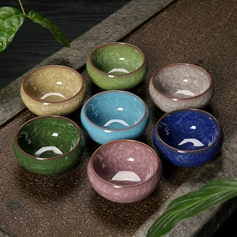 Set of seven vibrant ice cracking ceramic tea cups in green blue and pink hues perfect for dining room decorbites decor