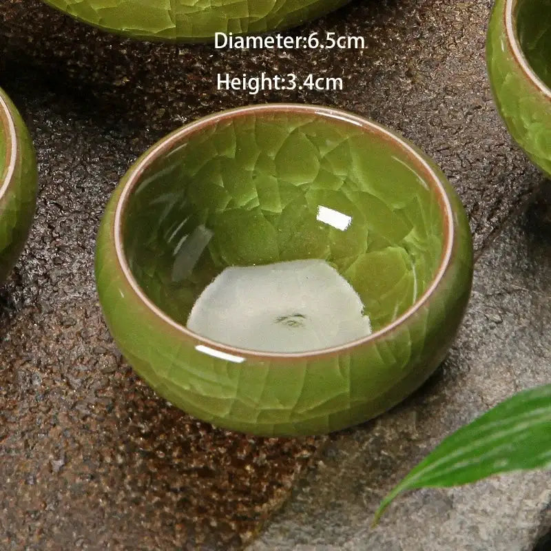 A small round ice cracking ceramic tea cup with crackled green glaze and brown rim for decorbites kitchen decor